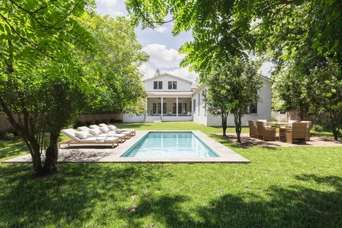 a view of a house with swimming pool and sitting area