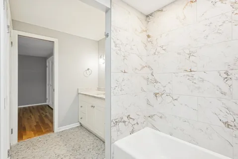 a bathroom with a bathtub and shower