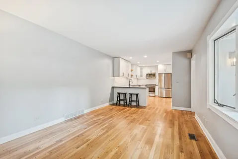 a view of kitchen with wooden floor and electronic appliances