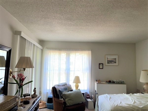 33 Castlegate Drive, Unit B Springfield, MA 01129 - Photo 11 of 18 a bedroom with a bed and large windows