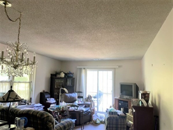 33 Castlegate Drive, Unit B Springfield, MA 01129 - Photo 7 of 18 a living room with furniture a window and a flat screen tv