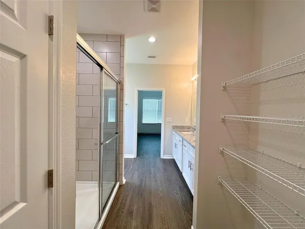 a view of a hallway with a white walls and stairs