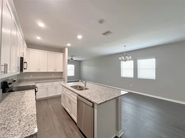 a kitchen with a stove a sink and a refrigerator