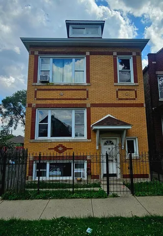 a front view of a house with lots of yellow lighting