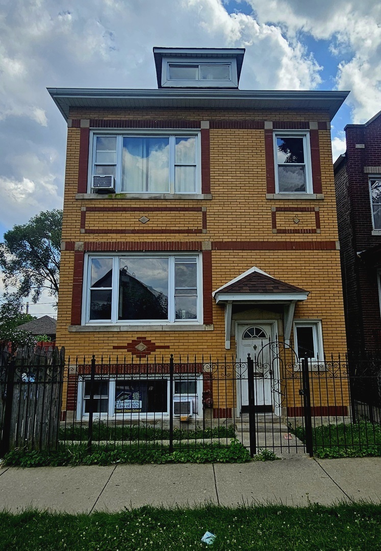 a front view of a house with lots of yellow lighting