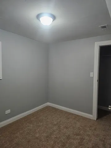 an empty room with a empty space and a window