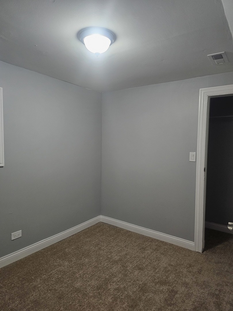 2441 West 46th Place, Unit 1 Chicago, IL 60632 - Photo 6 of 8 an empty room with a empty space and a window