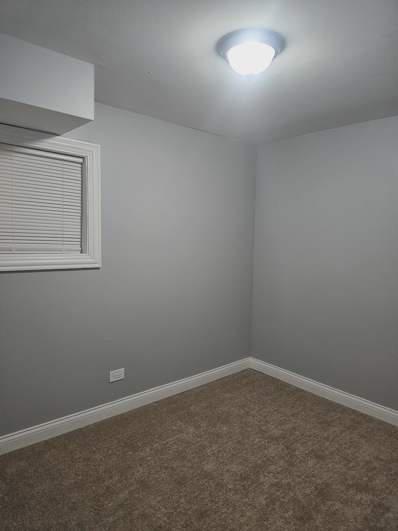 2441 West 46th Place, Unit 1 Chicago, IL 60632 - Photo 7 of 8 an empty room with a window