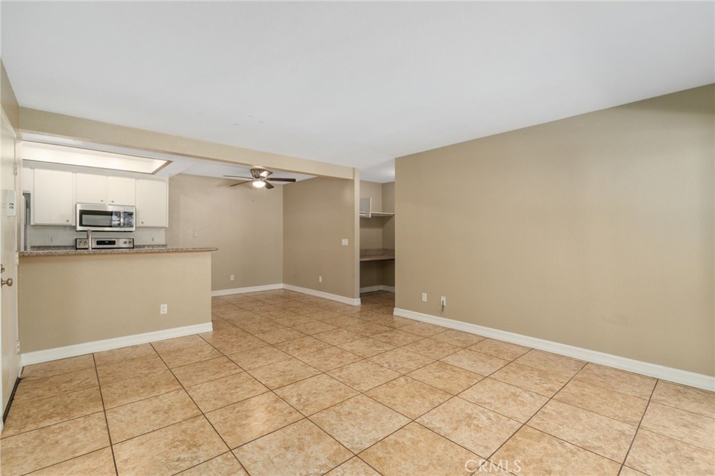 3535 Banbury Drive, Unit 119 Riverside, CA 92505 - Photo 5 of 23 a view of kitchen with white cabinets and refrigerator