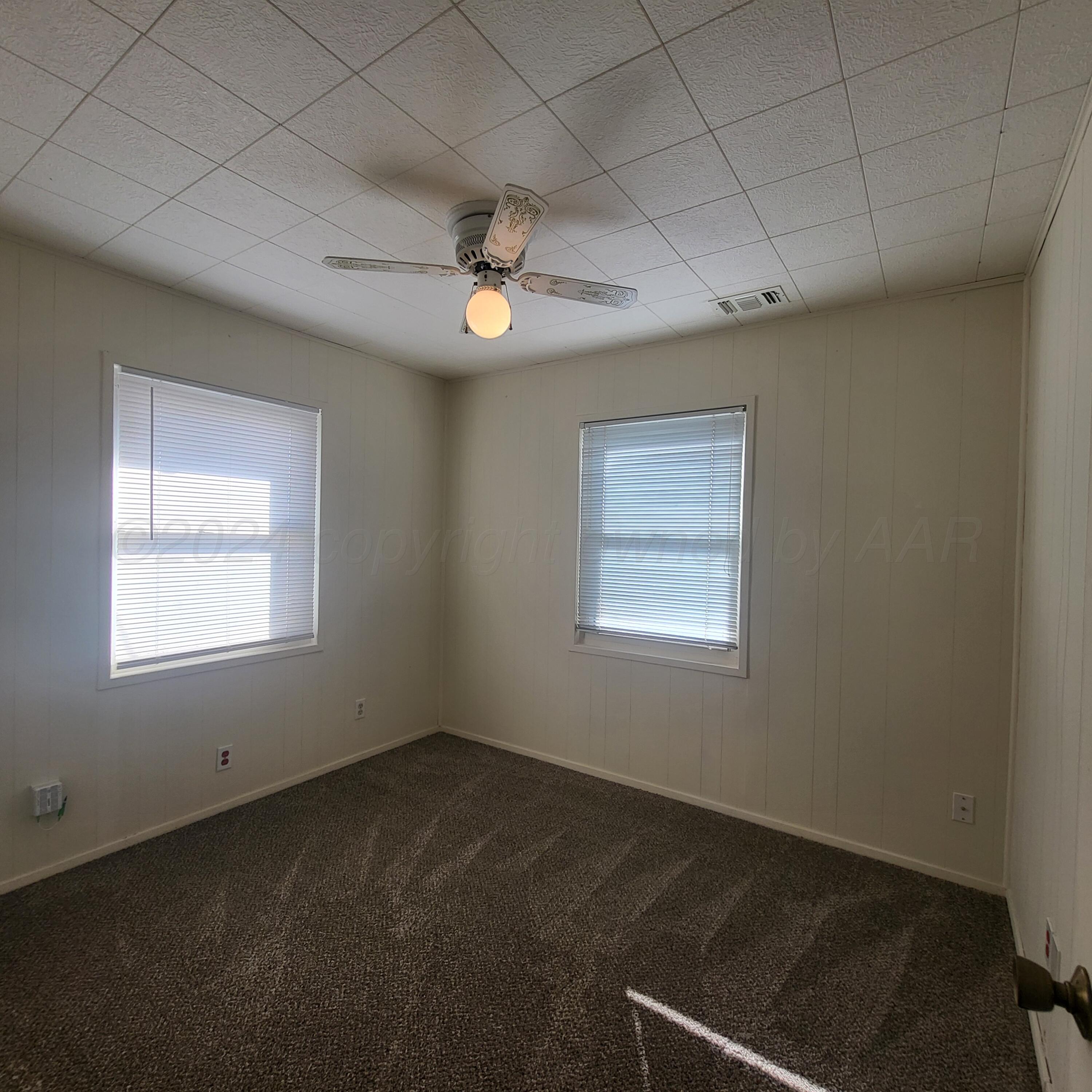4619 South Hughes Street Amarillo, TX 79110 - Photo 10 of 15 a view of a livingroom with a ceiling fan and window
