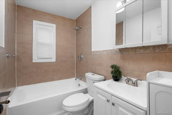 a bathroom with a sink a toilet and bathtub