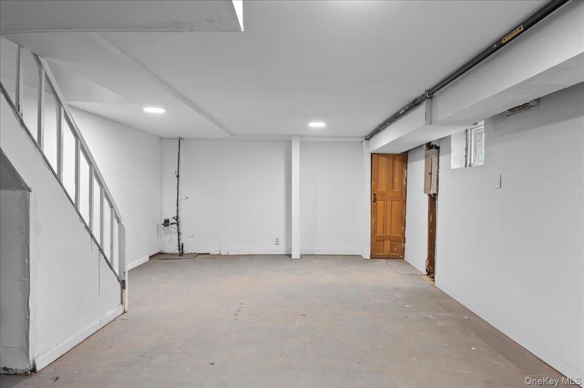 179-49 Zoller Road Queens, NY 11434 - Photo 15 of 21 a view of an empty room with wooden floor and stairs