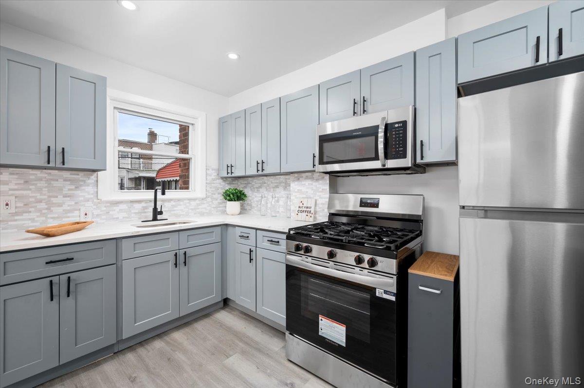 179-49 Zoller Road Queens, NY 11434 - Photo 4 of 21 a kitchen with cabinets stainless steel appliances and a sink