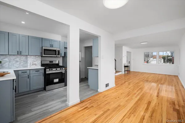 a kitchen with a refrigerator and a stove top oven