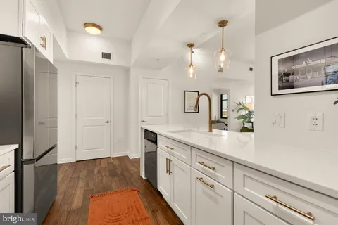 a spacious bathroom with a double vanity sink and mirror