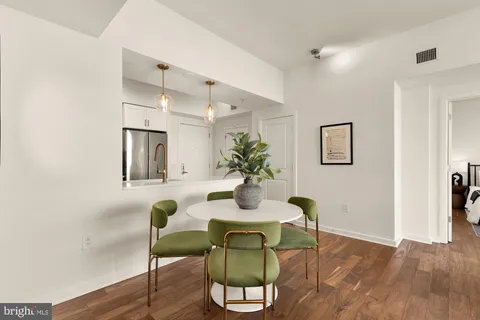 a view of a dining room with furniture and wooden floor