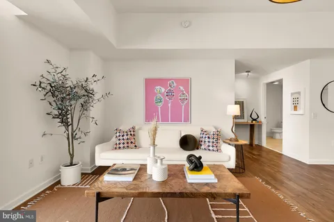 a view of a workspace with furniture and wooden floor