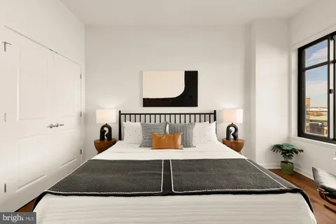 a bedroom with a bed and a window