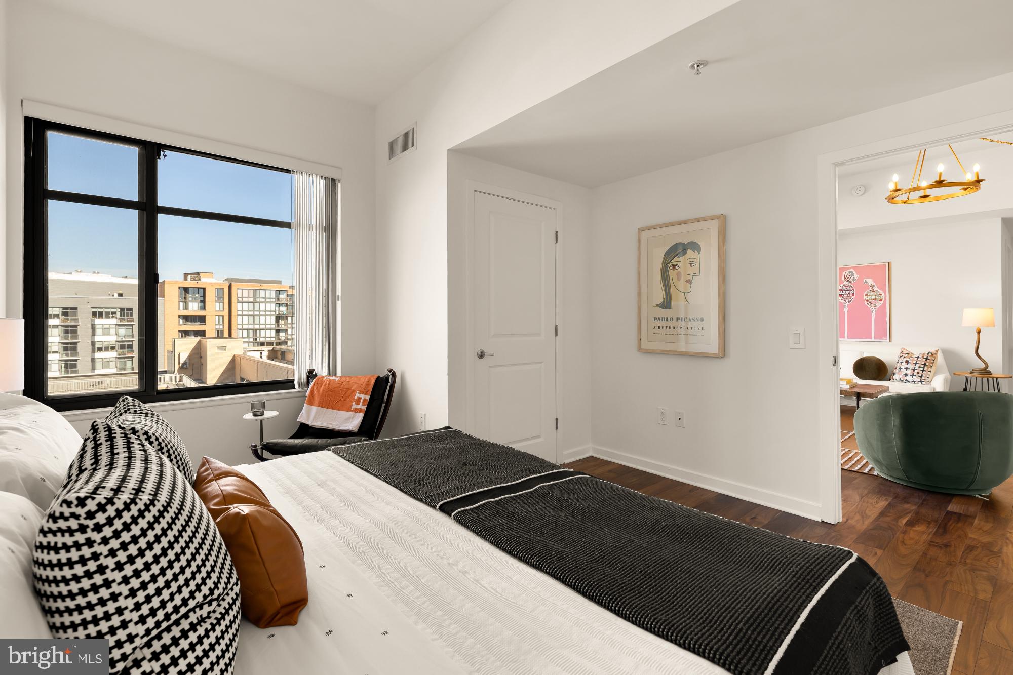 475 K Street Northwest, Unit 1126 Washington, DC 20001 - Photo 21 of 51 a bedroom with a bed and wooden floor