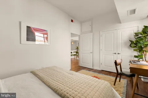 a bedroom with a bed and a table in it