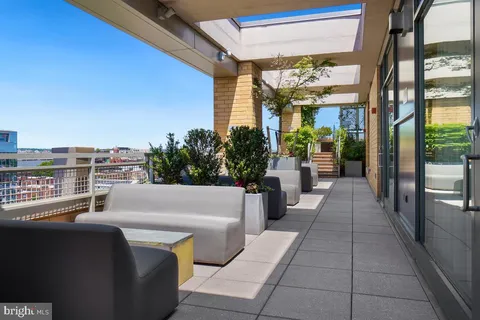 a view of a balcony with furniture
