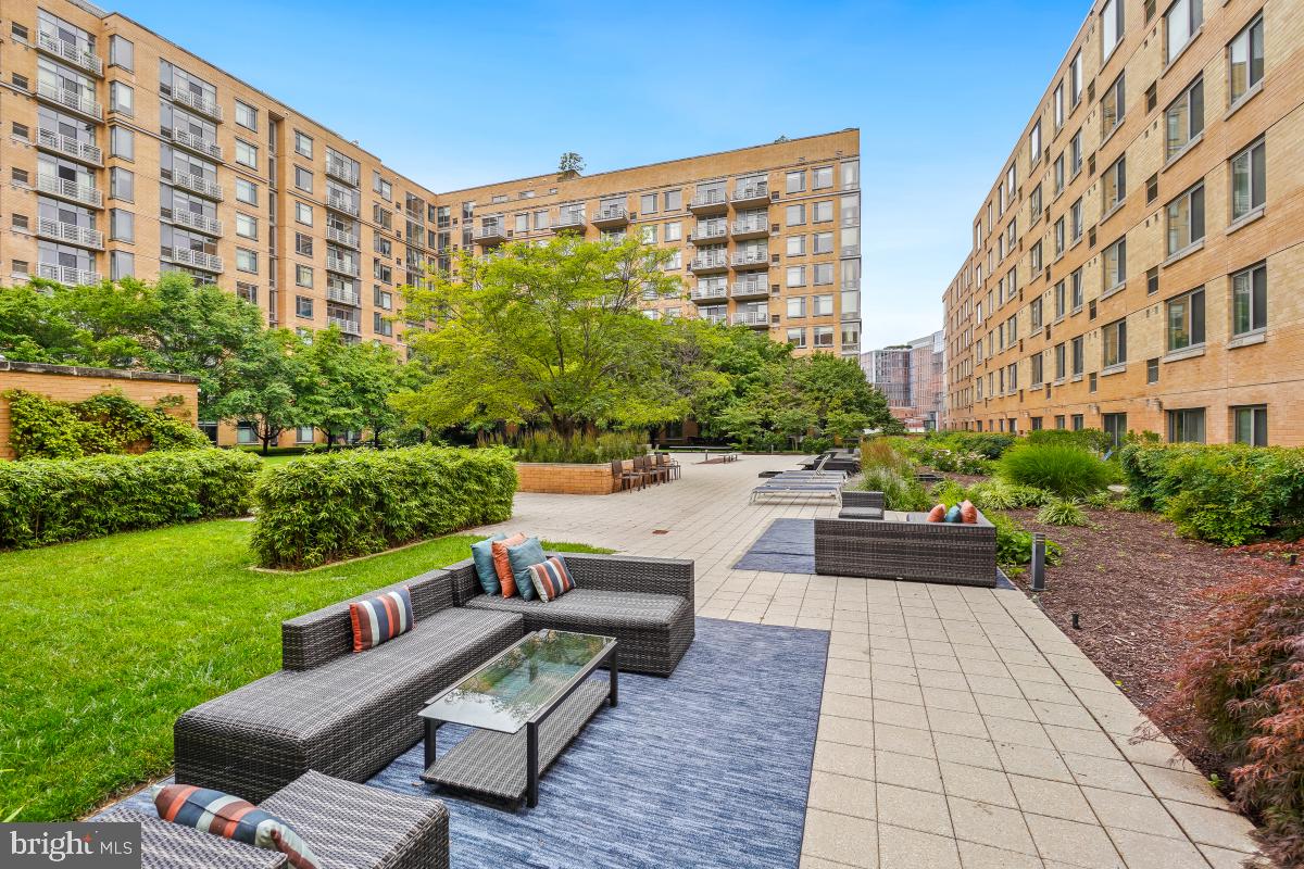 475 K Street Northwest, Unit 1126 Washington, DC 20001 - Photo 46 of 51 a view of a patio with couches and a table and chairs with garden