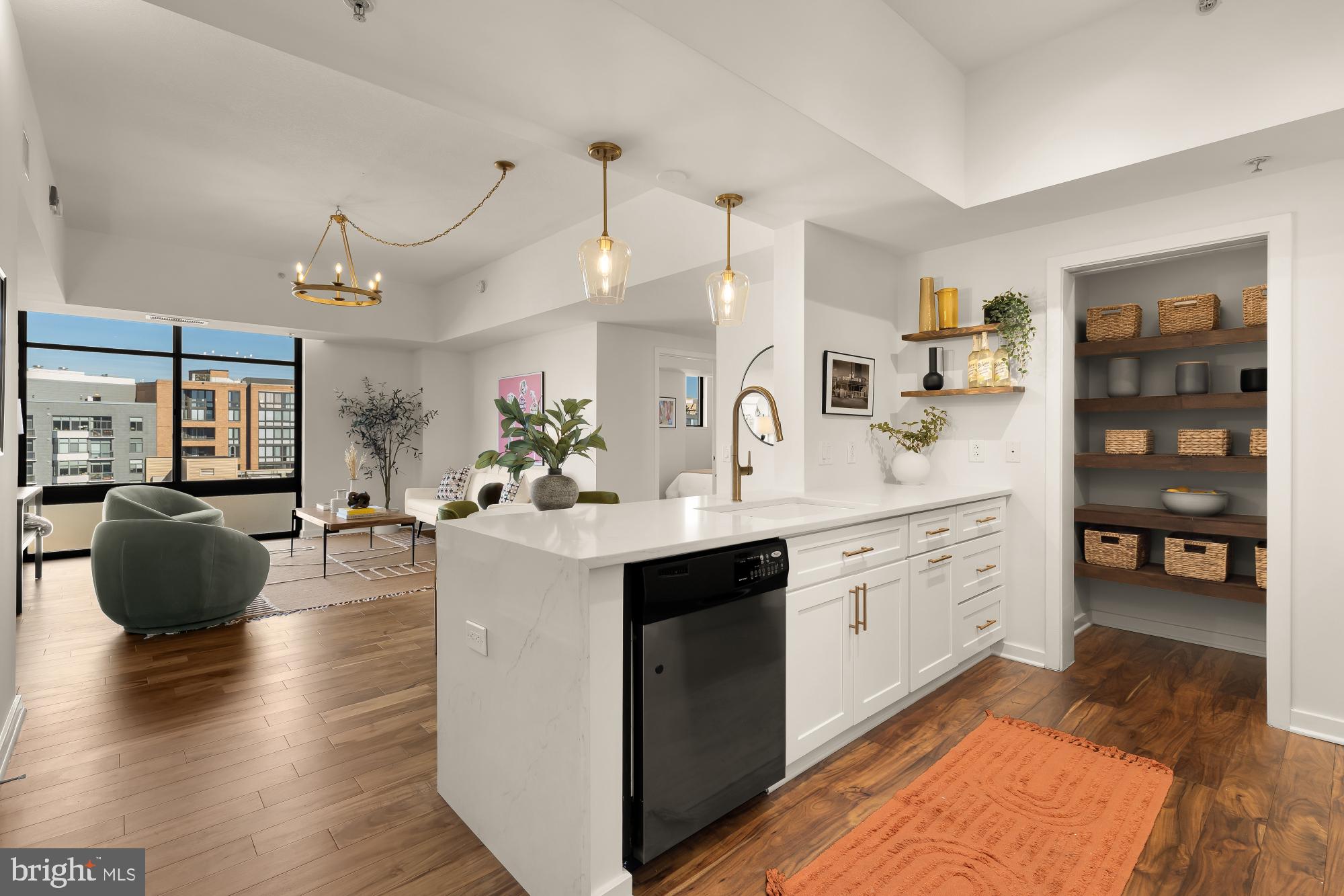 475 K Street Northwest, Unit 1126 Washington, DC 20001 - Photo 6 of 51 a large white kitchen with stainless steel appliances granite countertop a stove a sink a dining table and chairs