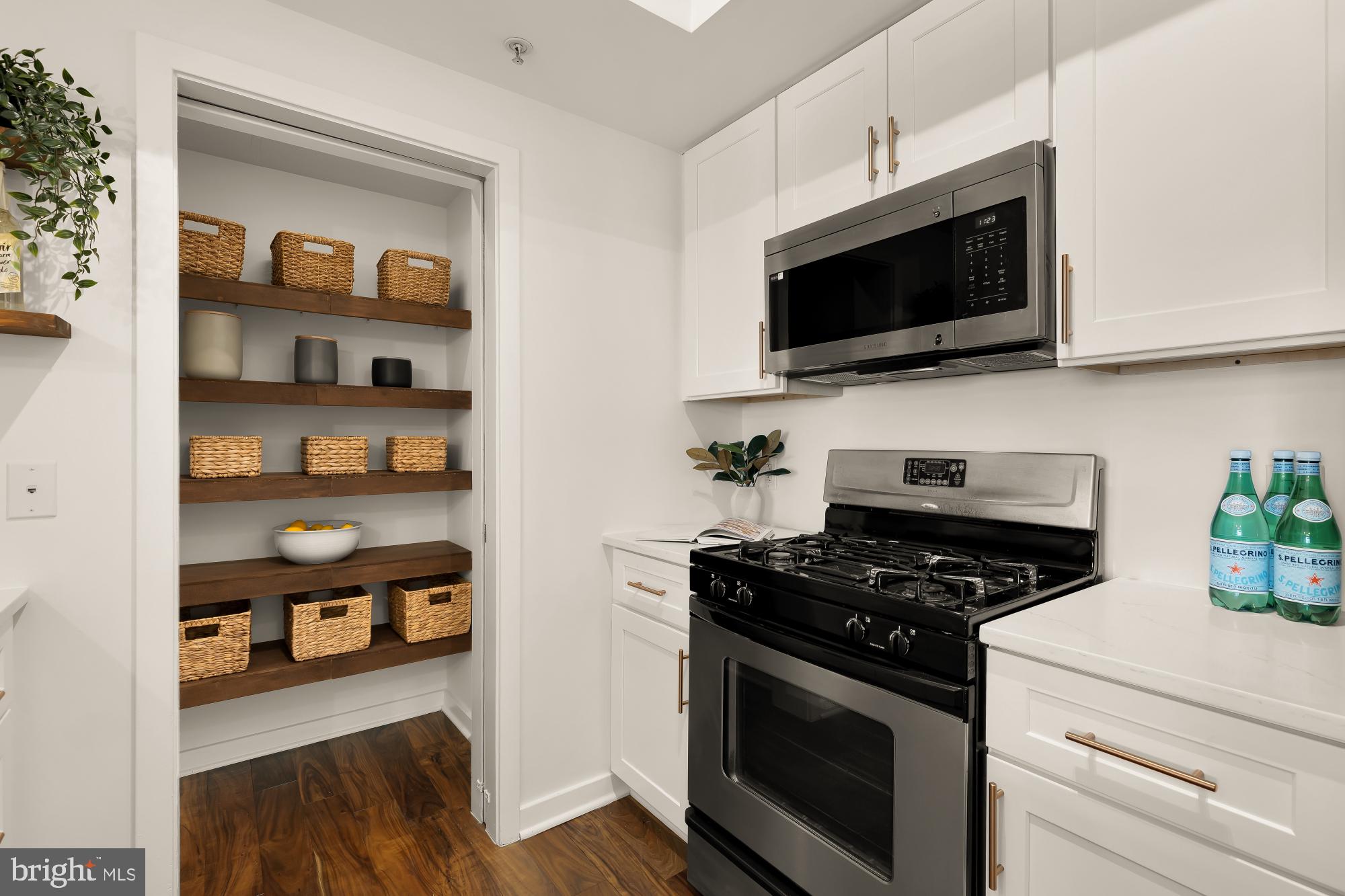 475 K Street Northwest, Unit 1126 Washington, DC 20001 - Photo 8 of 51 a kitchen with stainless steel appliances a stove a microwave and cabinets
