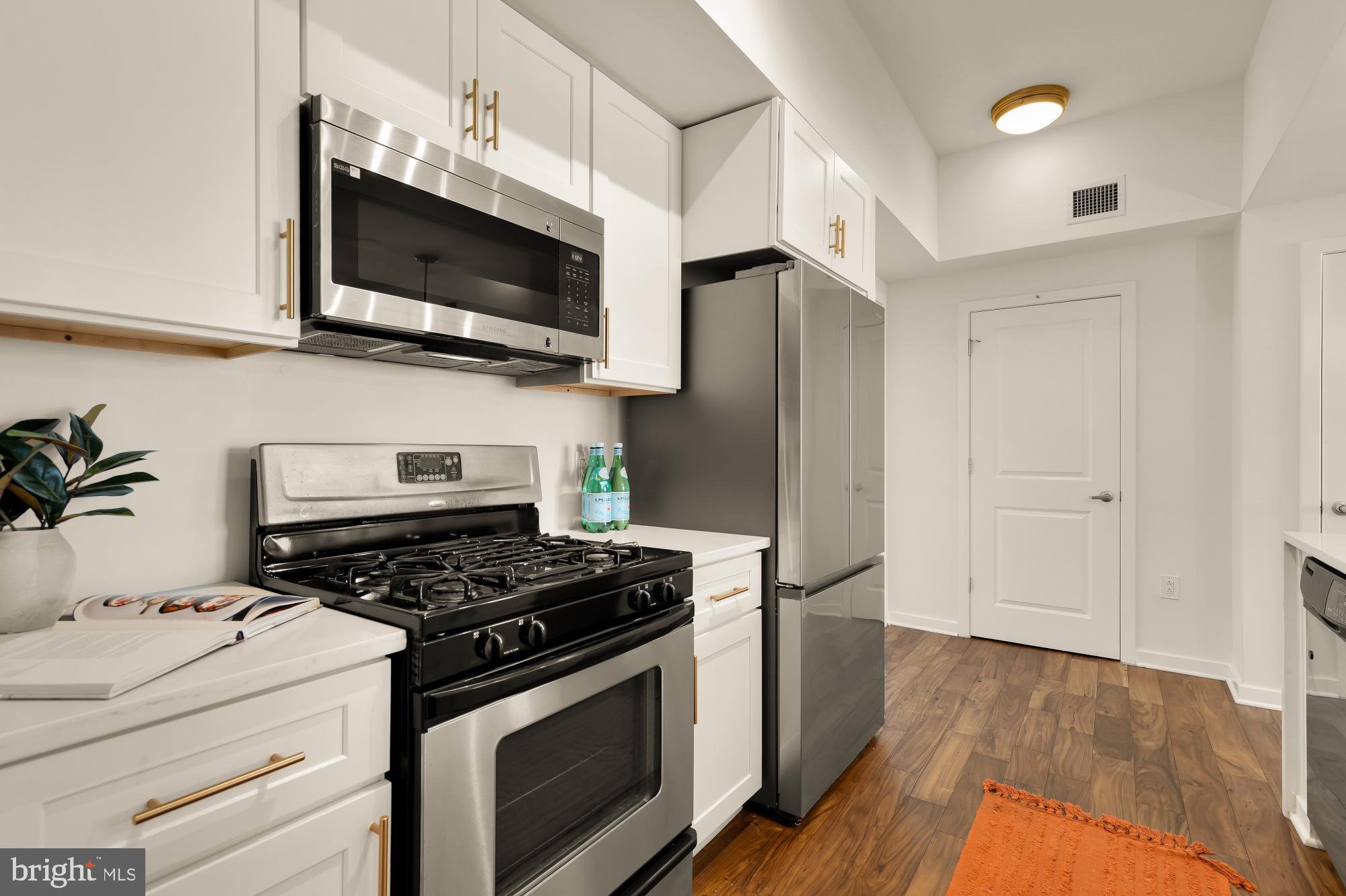 475 K Street Northwest, Unit 1126 Washington, DC 20001 - Photo 9 of 51 a kitchen with a stove and a microwave