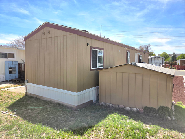 597 North State Street, Unit 67 Orem, UT 84057 - Photo 23 of 23 View of property exterior featuring a storage unit and a lawn