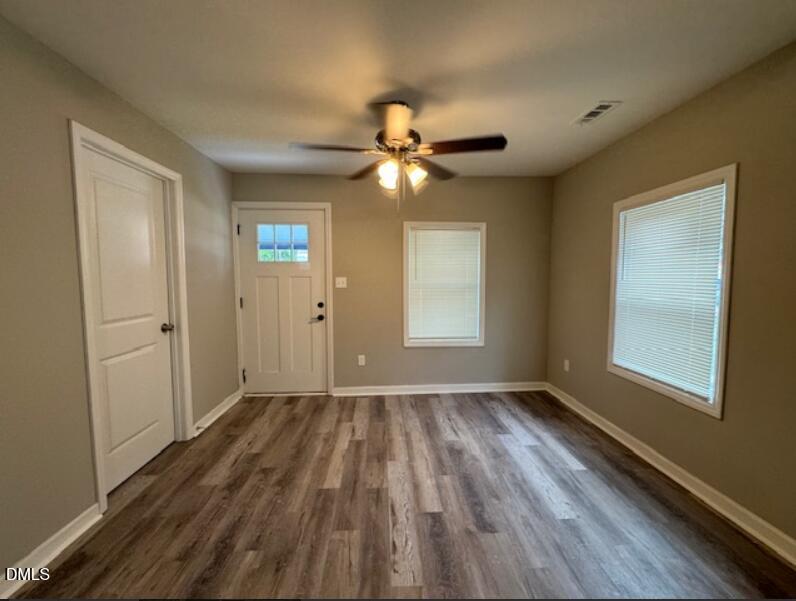 403 Spring Court Henderson, NC 27536 - Photo 2 of 7 wooden floor in an empty room with a window
