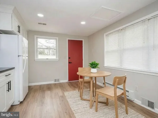 a kitchen with white cabinets and white appliances