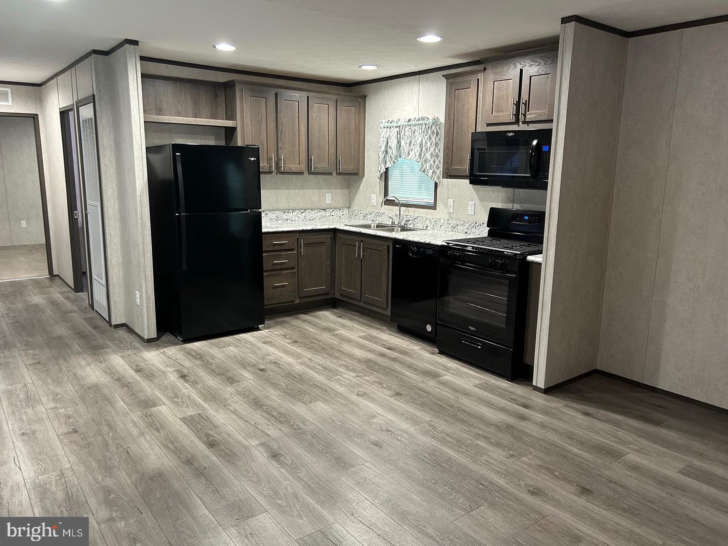 2501 Tilton Road, Unit 323 Egg Harbor Township, NJ 08234 - Photo 2 of 9 a kitchen with a refrigerator and a sink