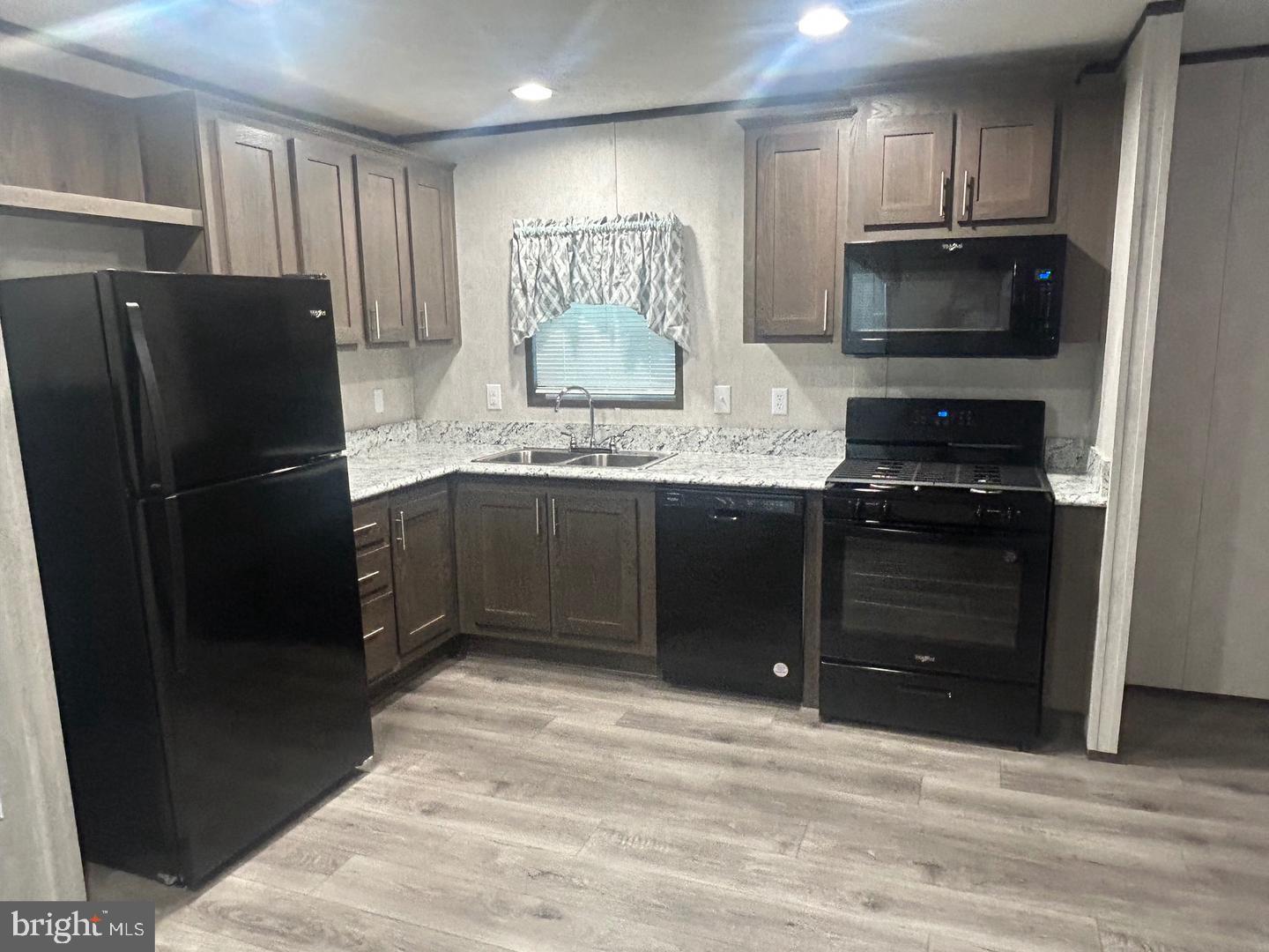 2501 Tilton Road, Unit 323 Egg Harbor Township, NJ 08234 - Photo 4 of 9 a kitchen with granite countertop a refrigerator and a sink