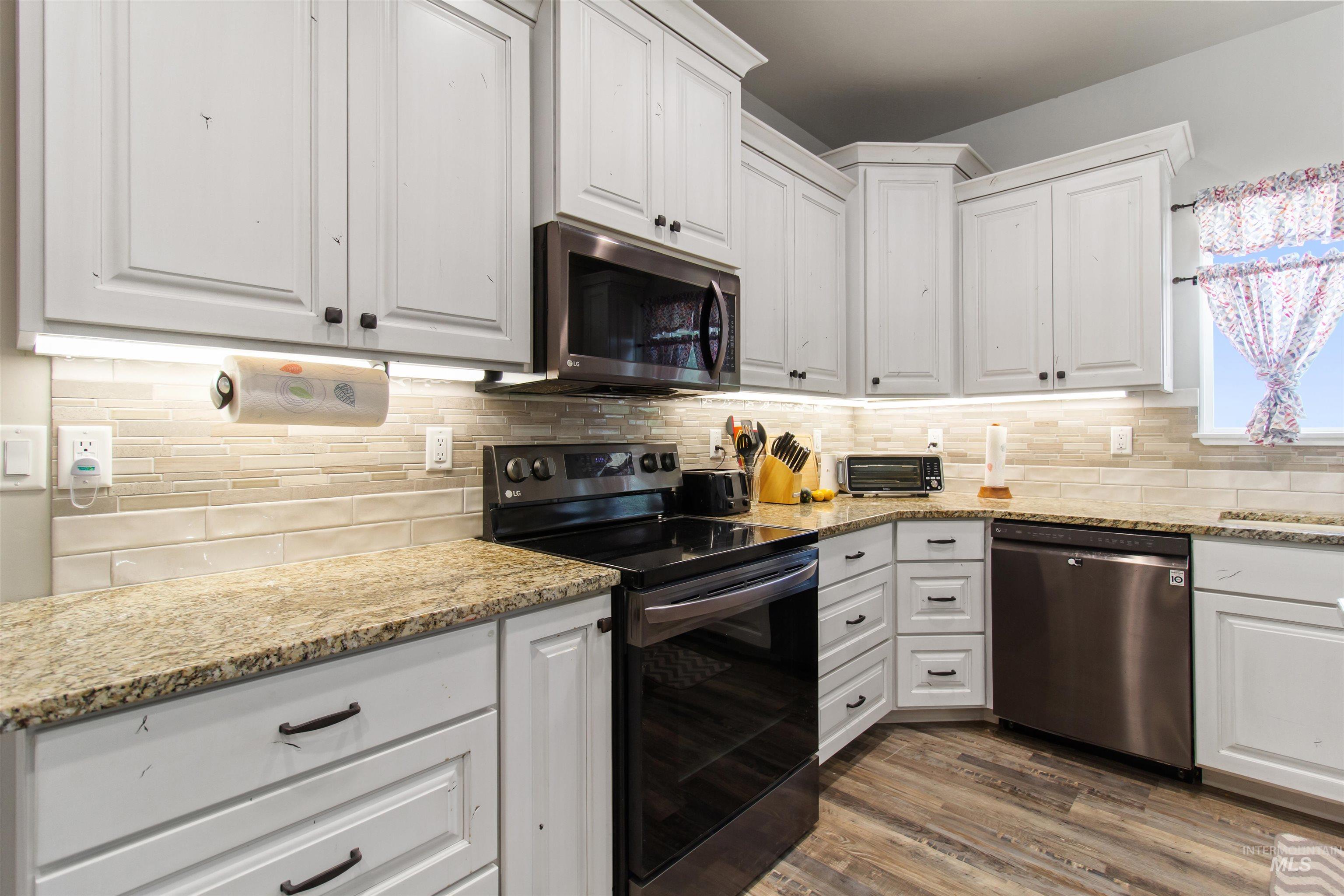 212 Fafnir Drive Kimberly, ID 83341 - Photo 13 of 36 Kitchen with stainless steel appliances, white cabinetry, and light stone counters