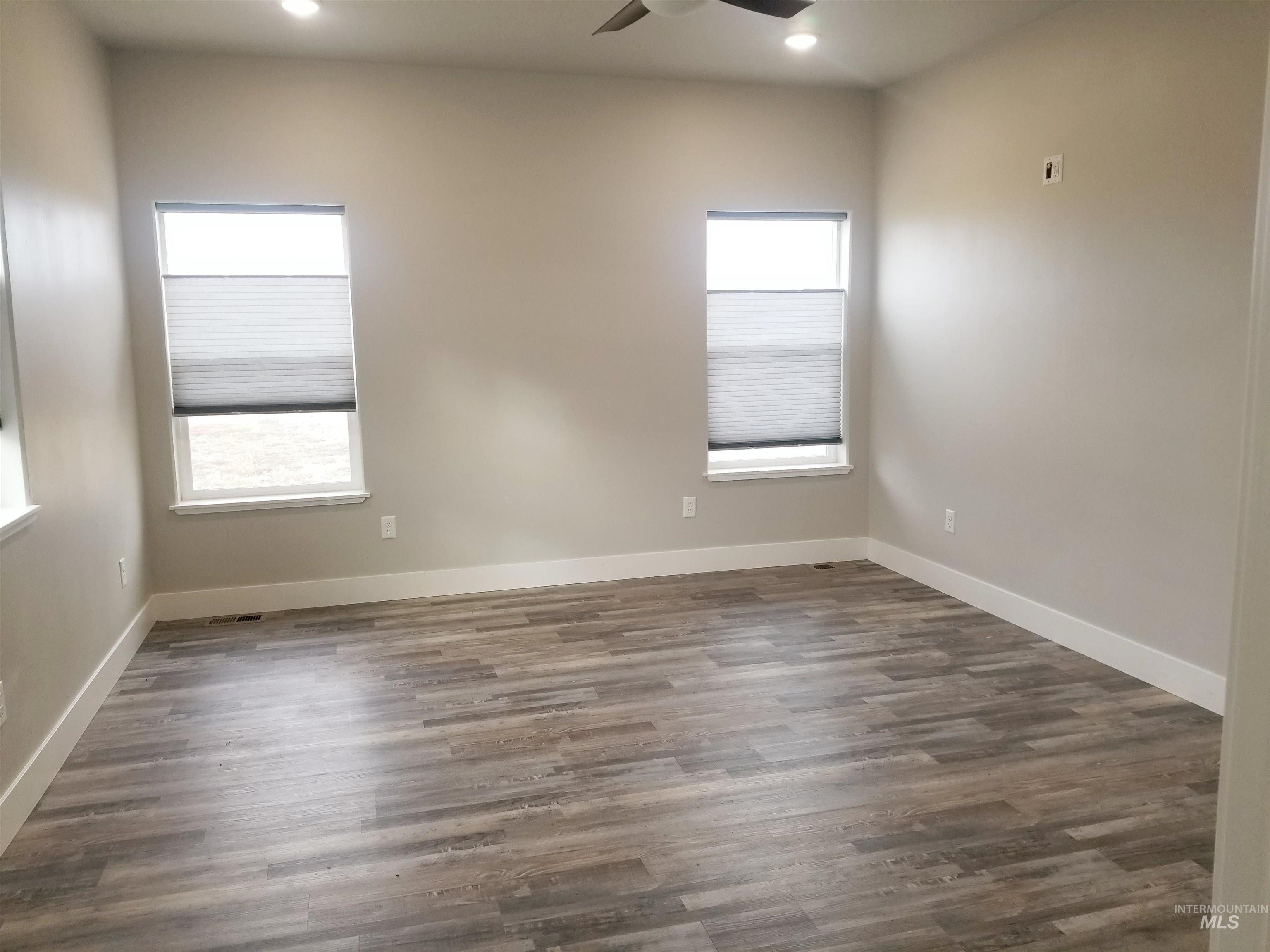 212 Fafnir Drive Kimberly, ID 83341 - Photo 15 of 36 Empty room with ceiling fan, dark wood-style flooring, and recessed lighting