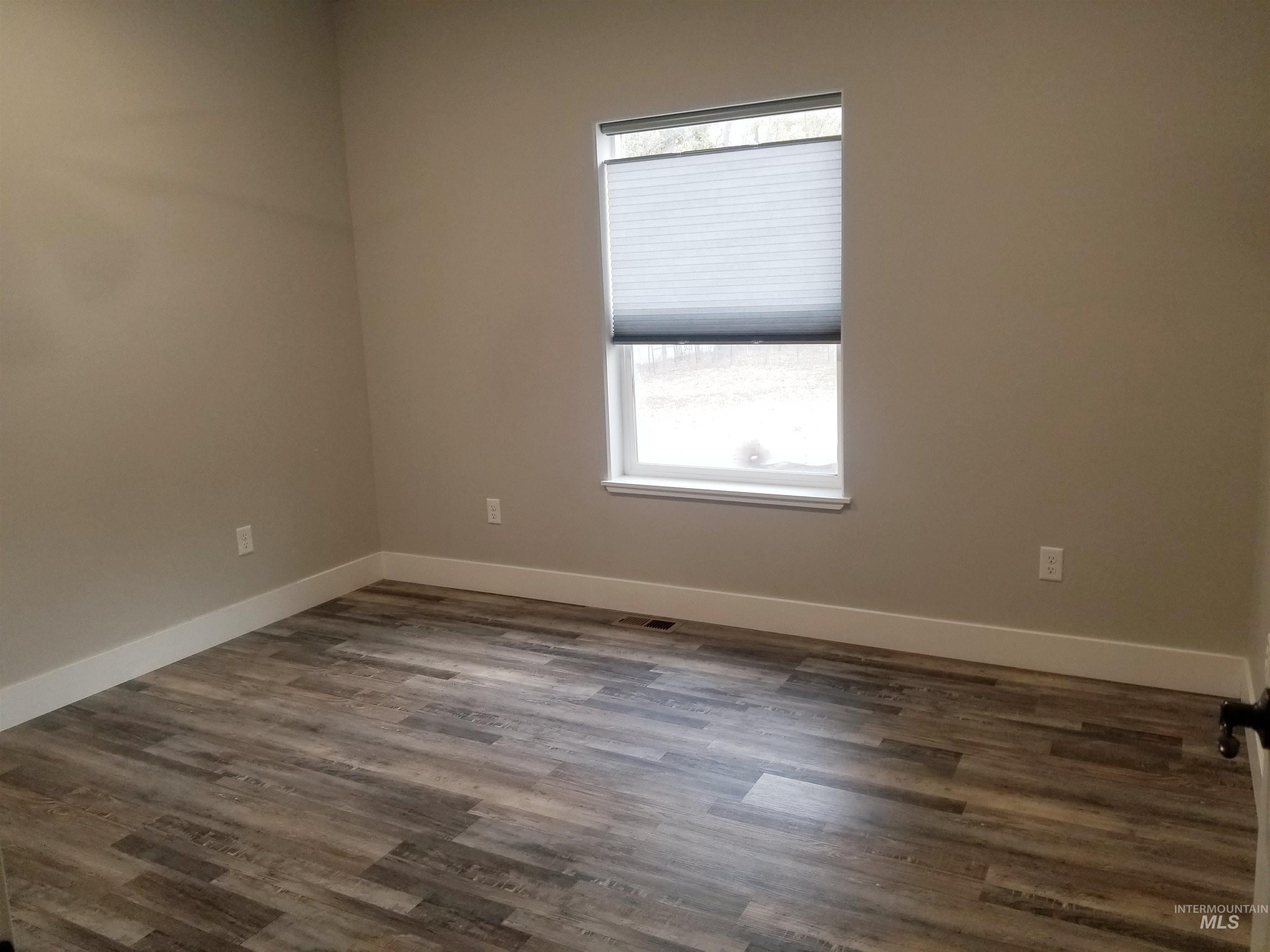 212 Fafnir Drive Kimberly, ID 83341 - Photo 23 of 36 Unfurnished room featuring baseboards and dark wood-type flooring