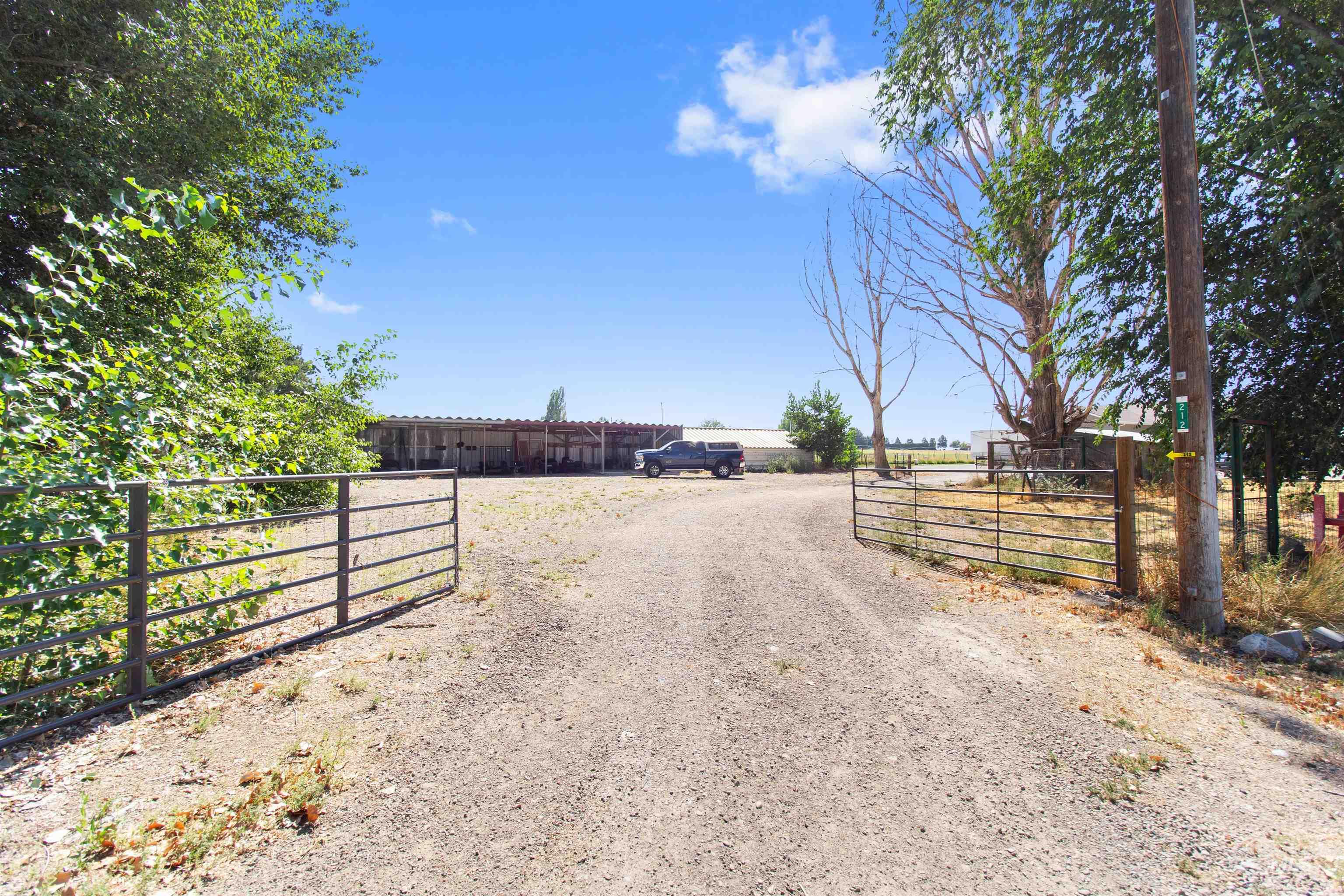 212 Fafnir Drive Kimberly, ID 83341 - Photo 3 of 36 View of dirt / gravel driveway featuring a gated entry, a gate, and a view of countryside