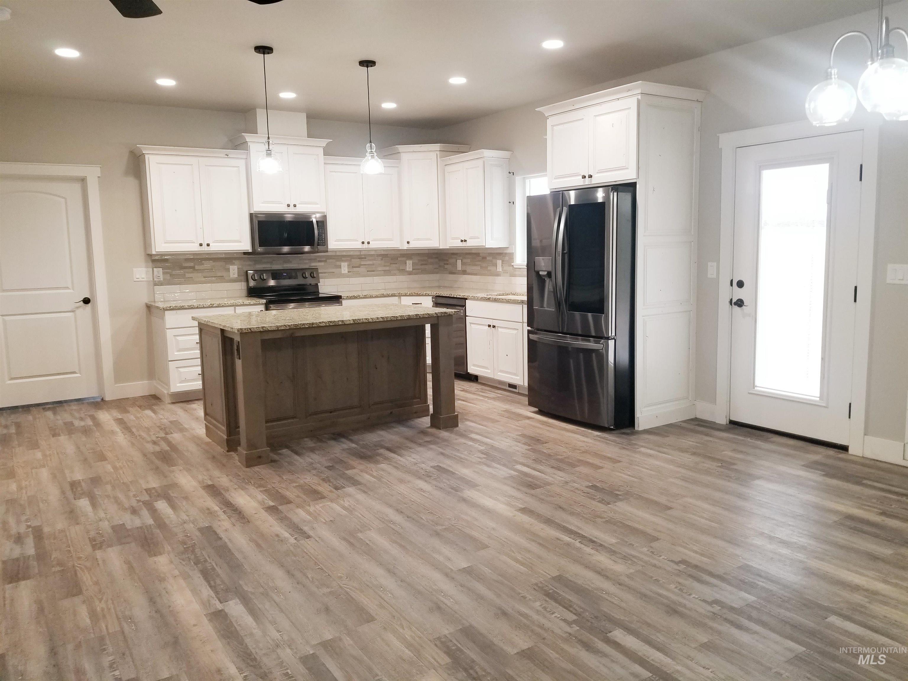 212 Fafnir Drive Kimberly, ID 83341 - Photo 7 of 36 Kitchen featuring hanging light fixtures, tasteful backsplash, appliances with stainless steel finishes, white cabinets, and recessed lighting