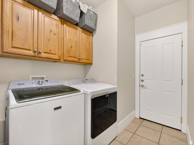 557 Craftsman Way Midway, UT 84049 - Photo 29 of 59 Utility room with light wood-finish cabinetry, neutral wall paint, and tile flooring