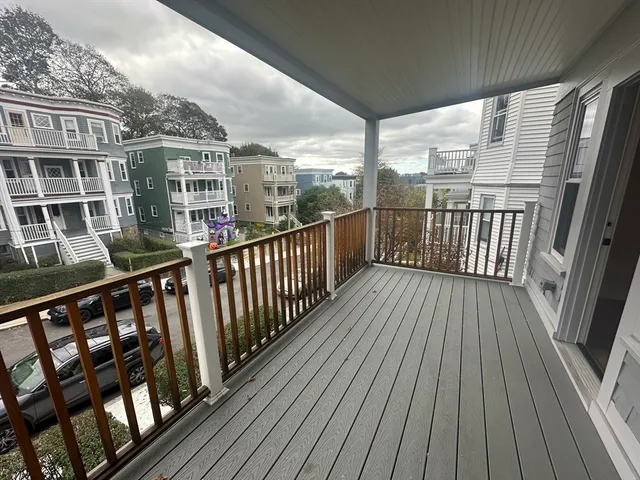 a view of a balcony with wooden floor