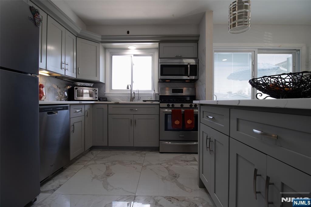 88 Columbia Street Wood-Ridge, NJ 07075 - Photo 11 of 32 a kitchen with stainless steel appliances granite countertop a sink and cabinets