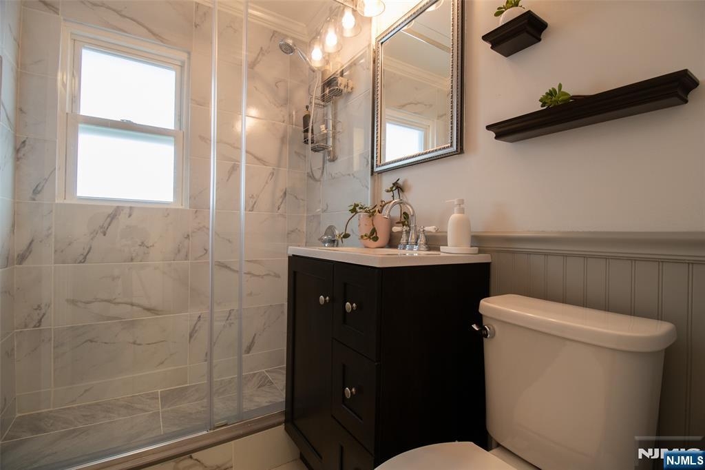 88 Columbia Street Wood-Ridge, NJ 07075 - Photo 18 of 32 a bathroom with a sink vanity mirror and toilet