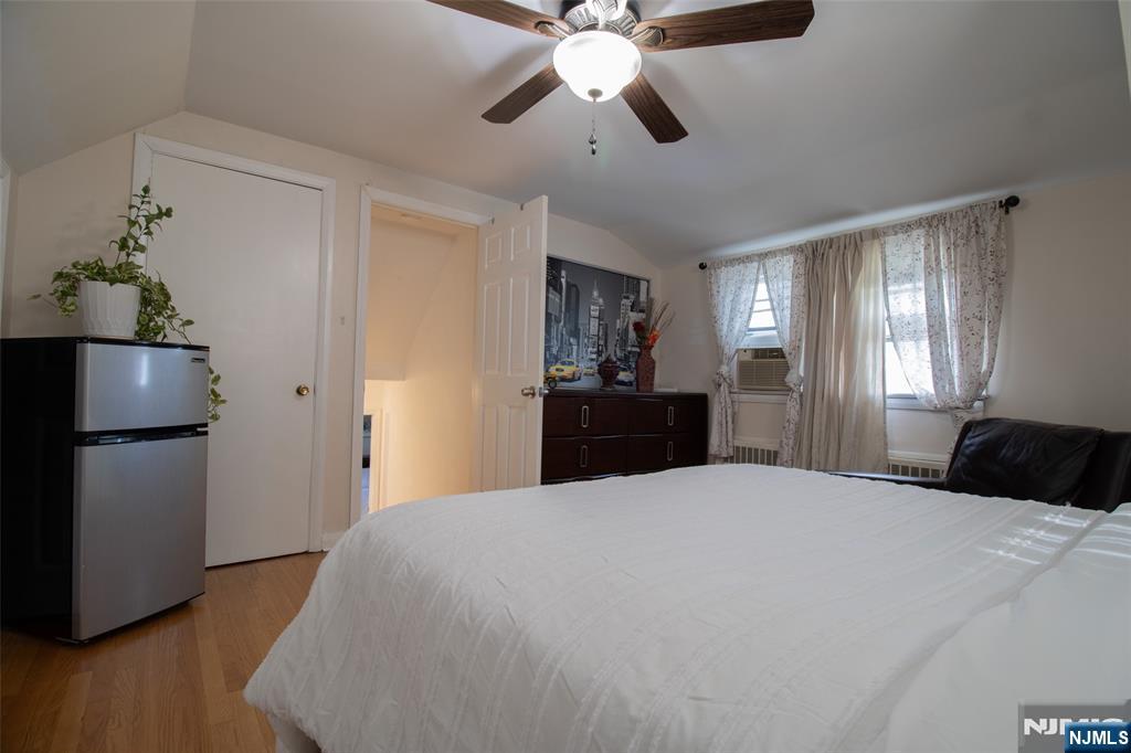 88 Columbia Street Wood-Ridge, NJ 07075 - Photo 23 of 32 a large bedroom with a bed and a chandelier