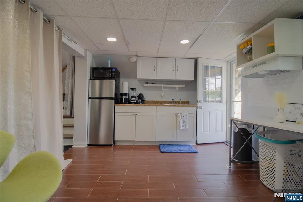 88 Columbia Street Wood-Ridge, NJ 07075 - Photo 27 of 32 a kitchen with a sink a refrigerator and cabinets