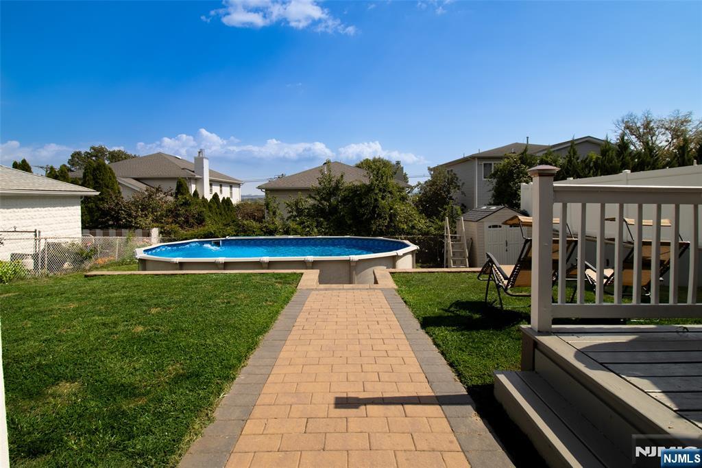 88 Columbia Street Wood-Ridge, NJ 07075 - Photo 6 of 32 a view of a swimming pool with a yard