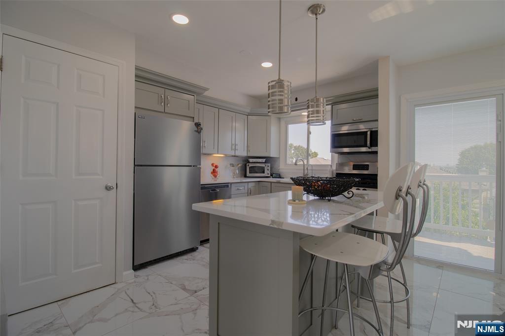 88 Columbia Street Wood-Ridge, NJ 07075 - Photo 9 of 32 a kitchen with refrigerator and cabinets