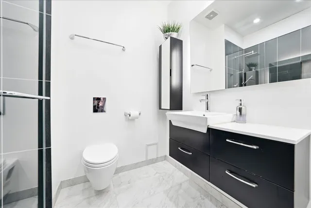 a spacious bathroom with a sink toilet and shower