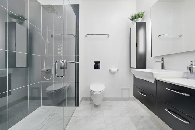 a bathroom with a toilet sink and shower