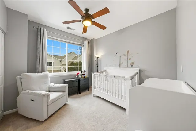 a bedroom with furniture and a large window